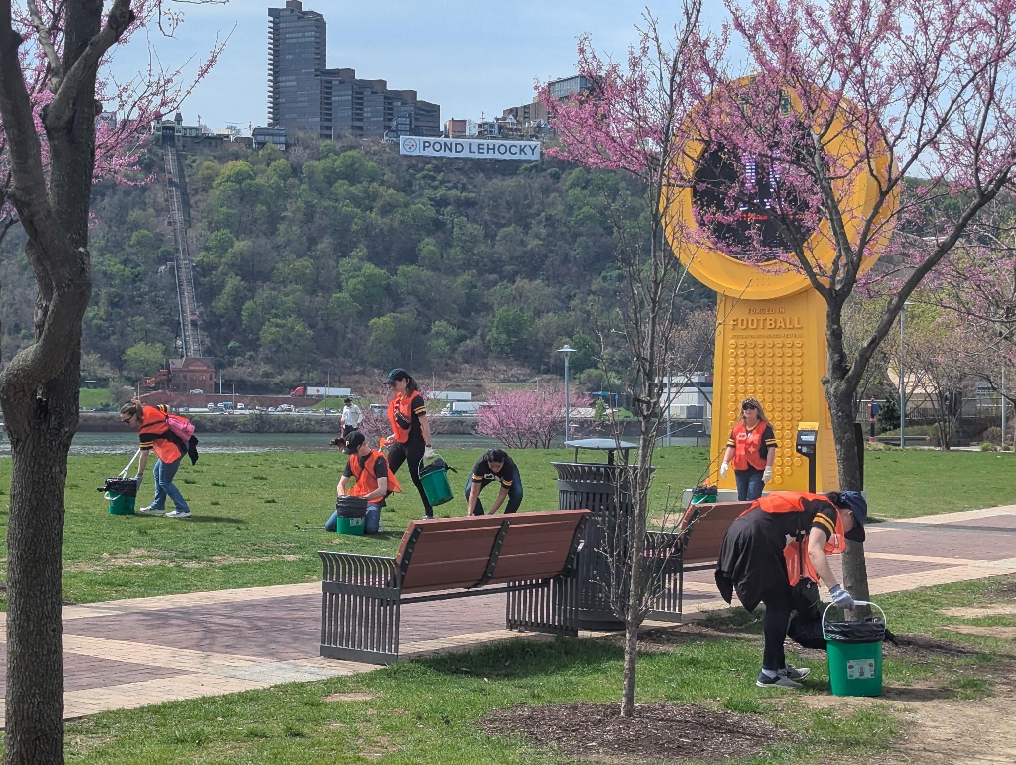 PMI Pittsburgh Volunteers in orange vests redding up the north shore.